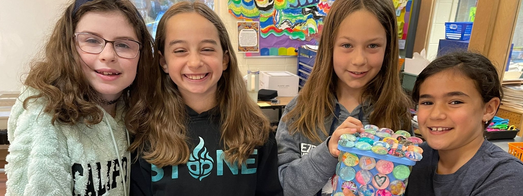 Girls holding a tzedaka box